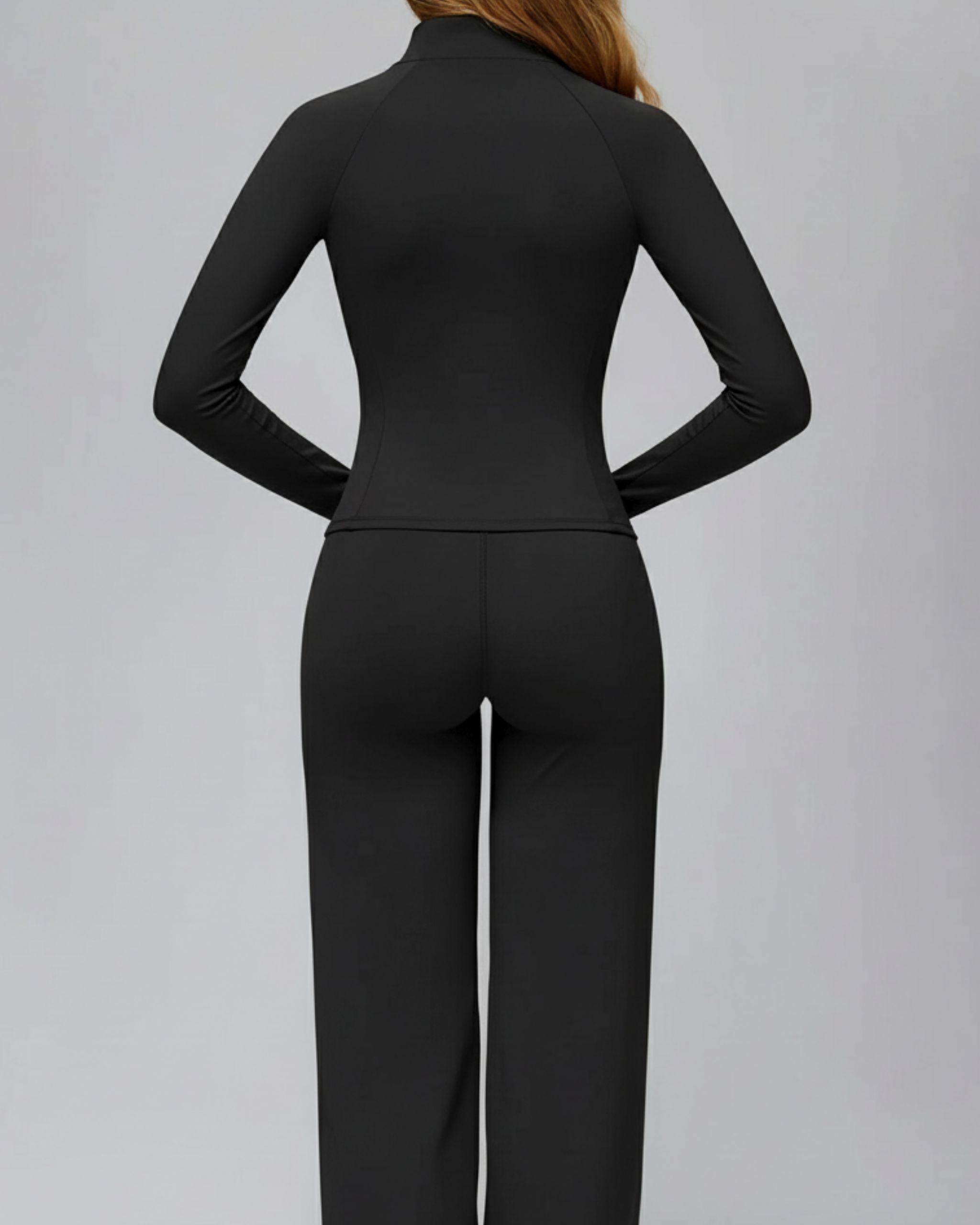 Rückansicht der schwarzen Slim-Fit Zip-Jacke, taillierte Passform durch formgebende Rückennähte, atmungsaktives Material, ideal für Laufen und Gym - Ryze.